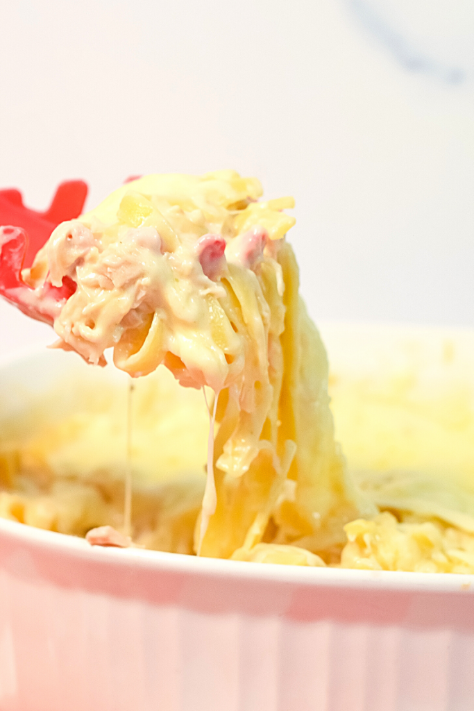 A close up scoop of chicken fettuccine alfredo pasta bake