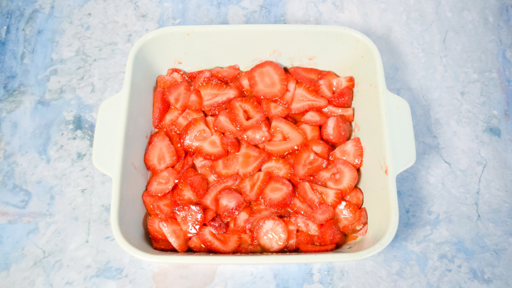 Strawberries sliced in the bottom of the baking dish