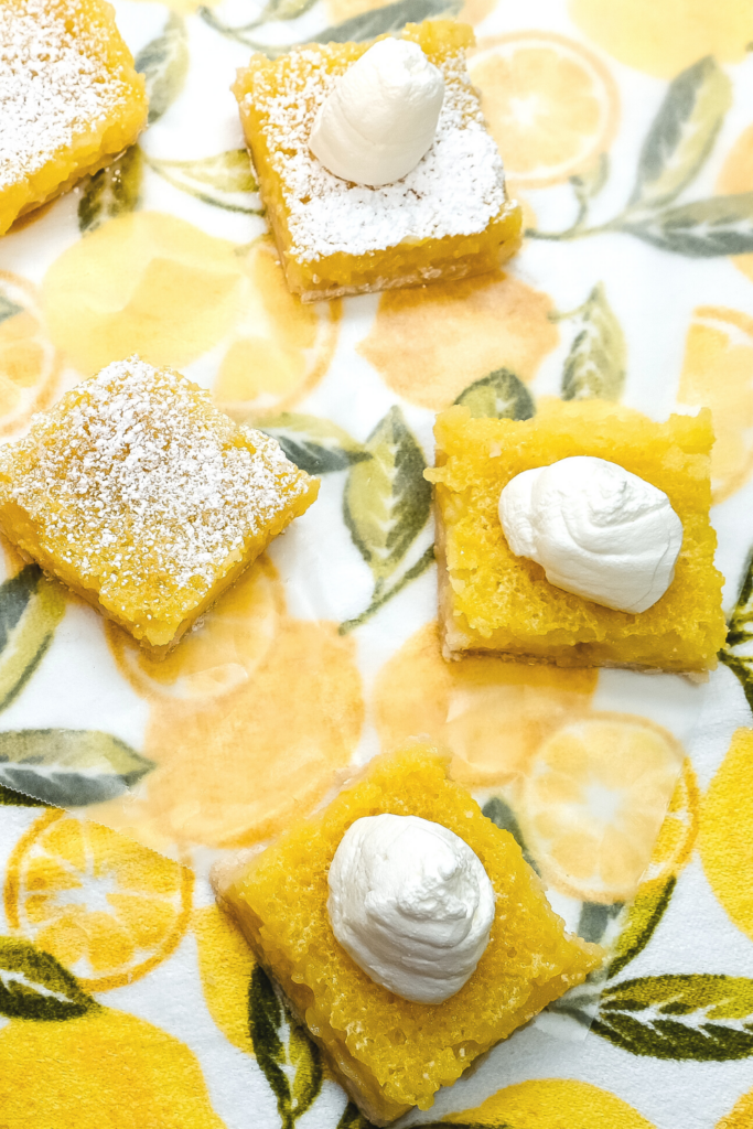 Squares of Microwave Lemon Bars on a lemon towel. 
