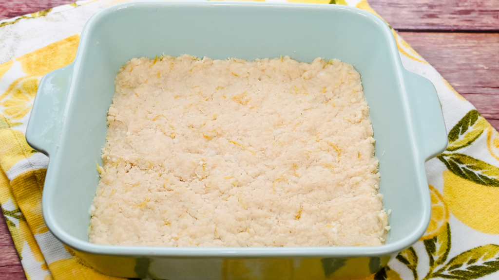 The microwave lemon bars crust pressed and cooked in an 8 x 8 microwave-safe baking dish. 