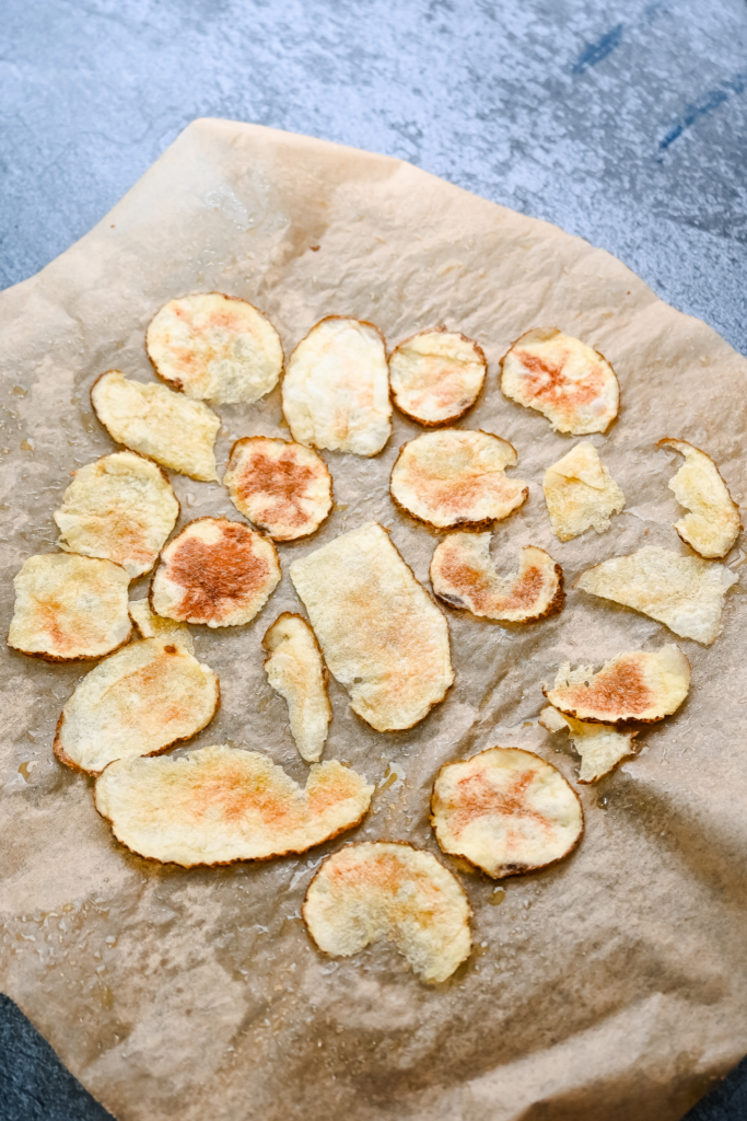 Microwave Potato Chips on parchment paper cooling. 