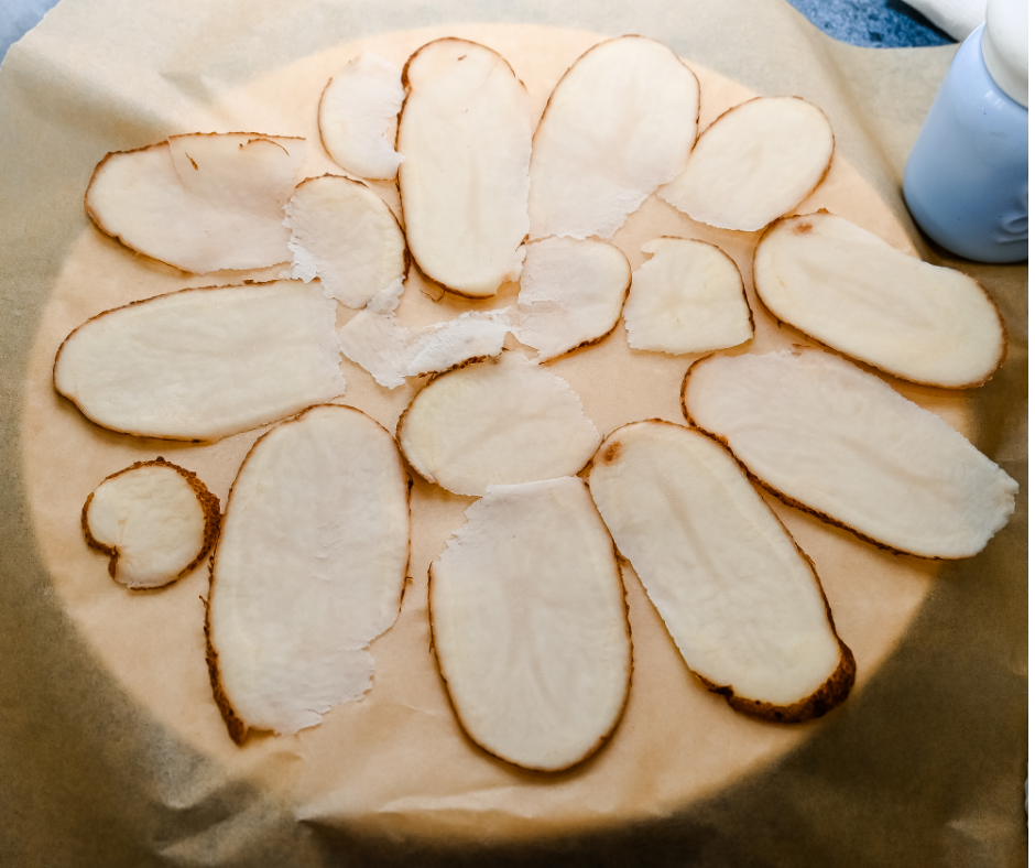 Laying the potato slices on brown parchment paper on a plate for the microwave