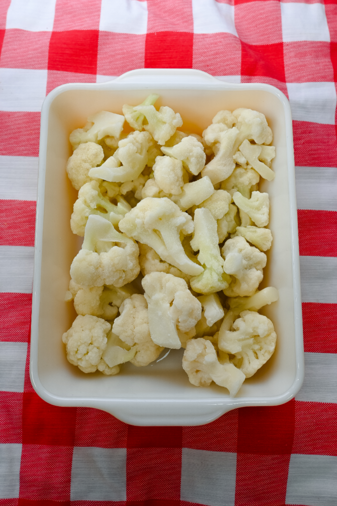 Frozen cauliflower in a casserole dish. 