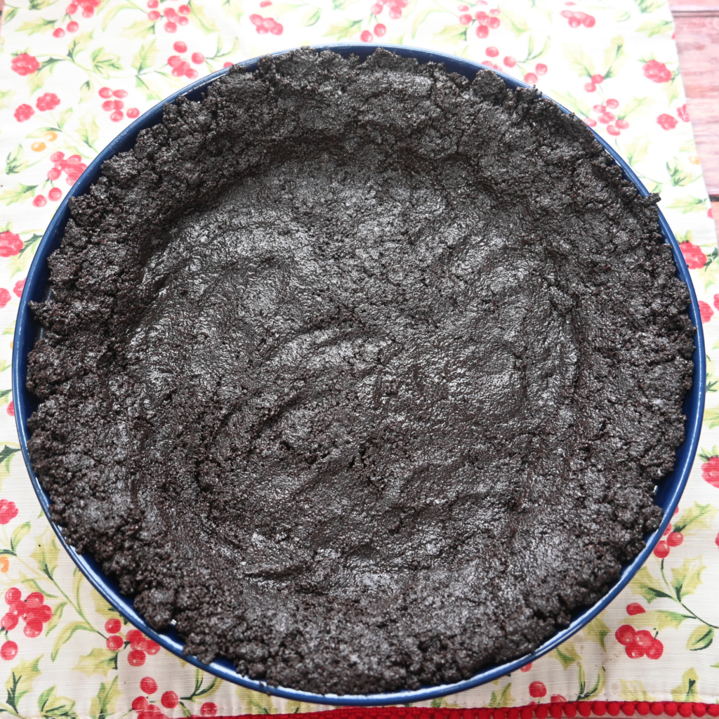The OREO cookie pie crust pressed into the pie plate