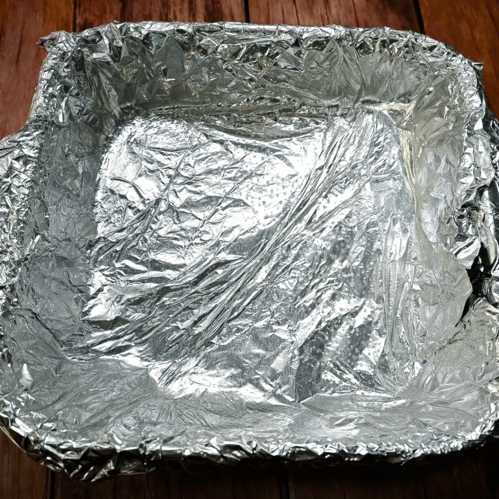 An 8 x 8 pan covered in foil. 