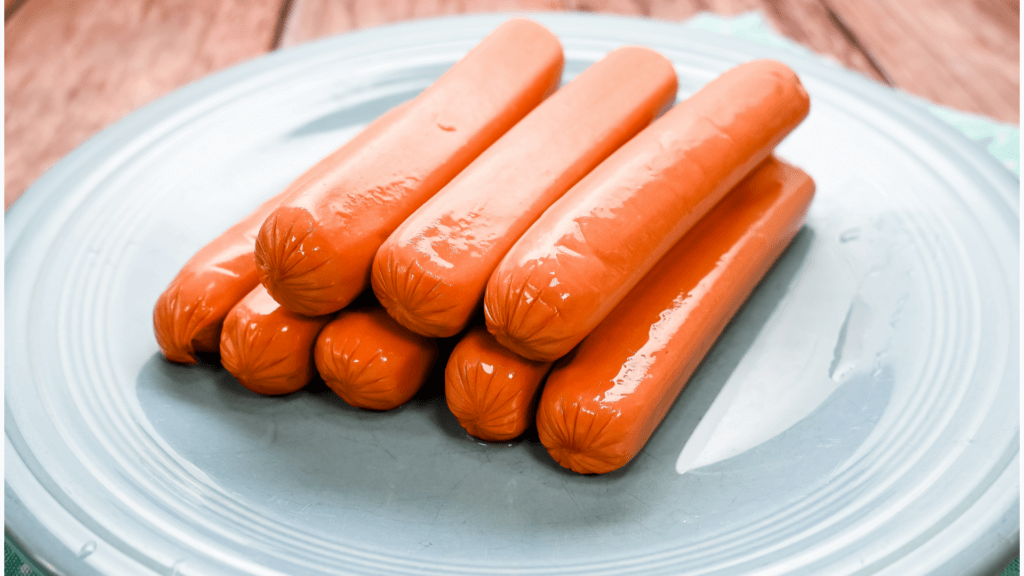 Hot Dogs on a blue plate fresh out of the package. 