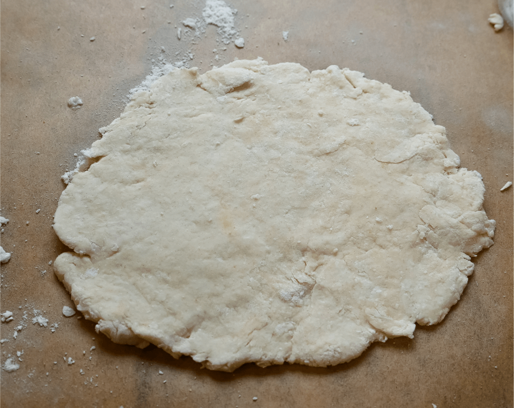 Rolled out pizza crust. 