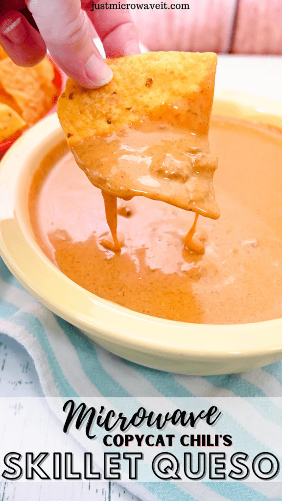 Close up image of a chip pulling up through the skillet queso in a yellow bowl. 