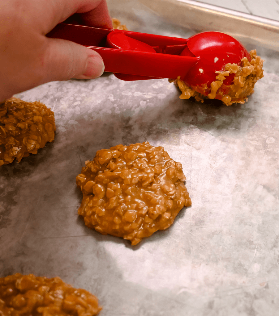 Scooping the no bake cookies on a cookie sheet. 
