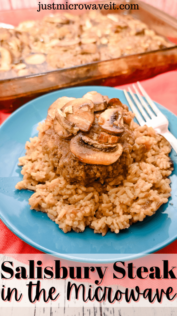Close up of a blue plate with french onion rice topped with a salisbury steak and mushrooms. in front of a casserole dish full of salisbury steaks and mushrooms