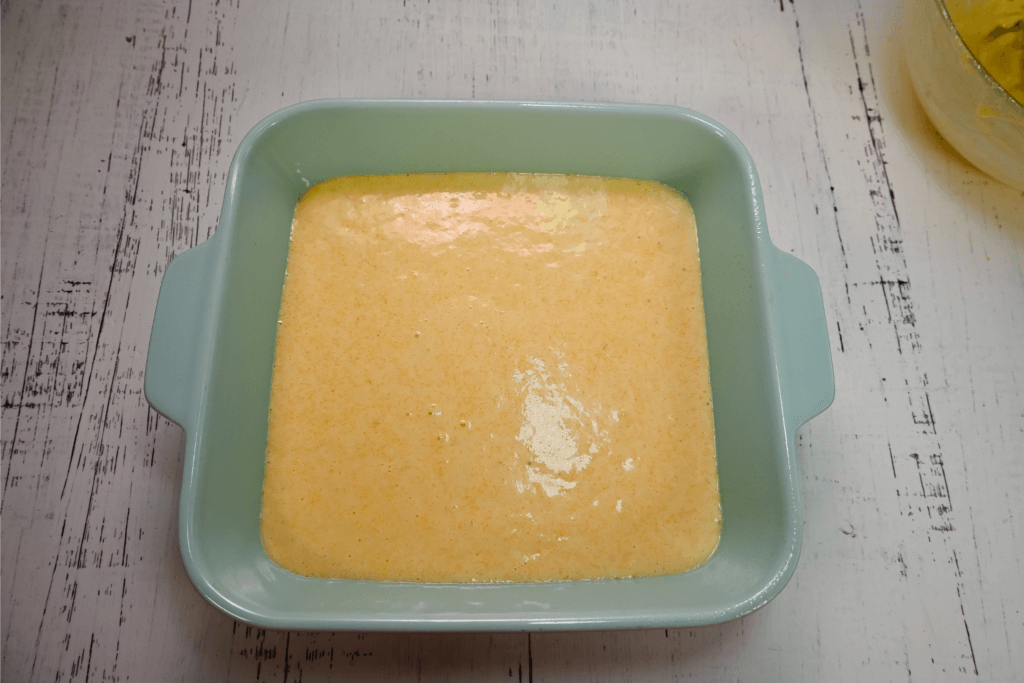 Light blue casserole dish with the cornbread batter before cooking
