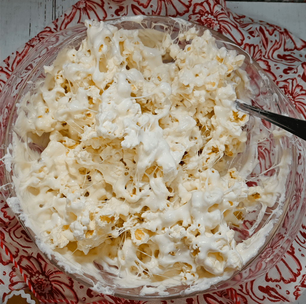 Marshmallow Popcorn in a glass bowl on a red floral towel