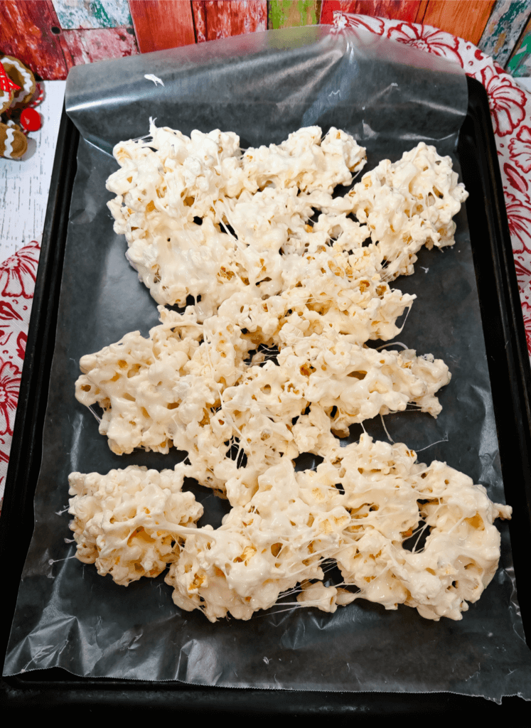 Cookie sheet with wax paper and the marshmallow popcorn