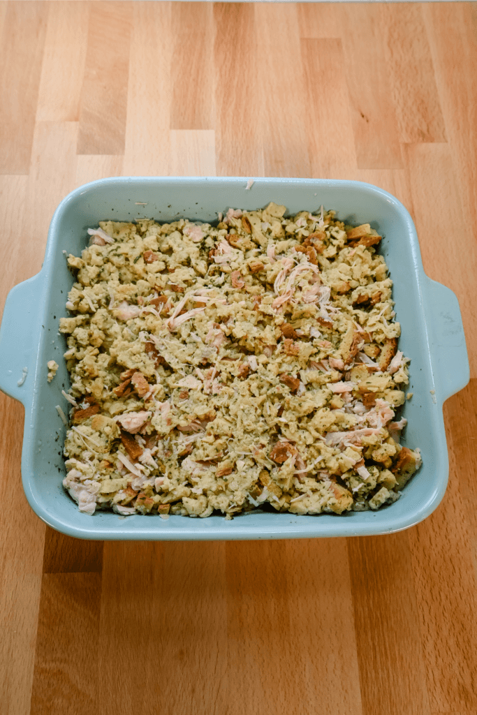 Mixing in the chicken into the stuffing mixture