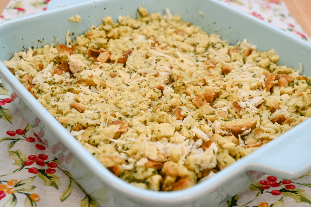 A close up image of the blue casserole with the finished microwave chicken and stuffing casserole