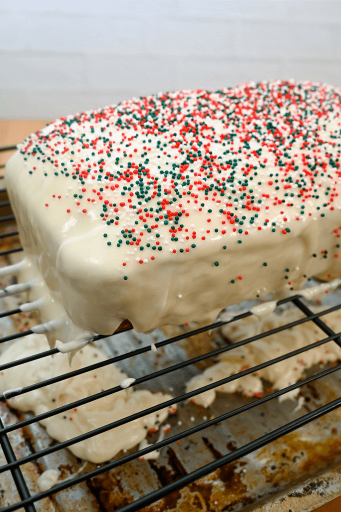 Cake with sprinkles and poured over frosting