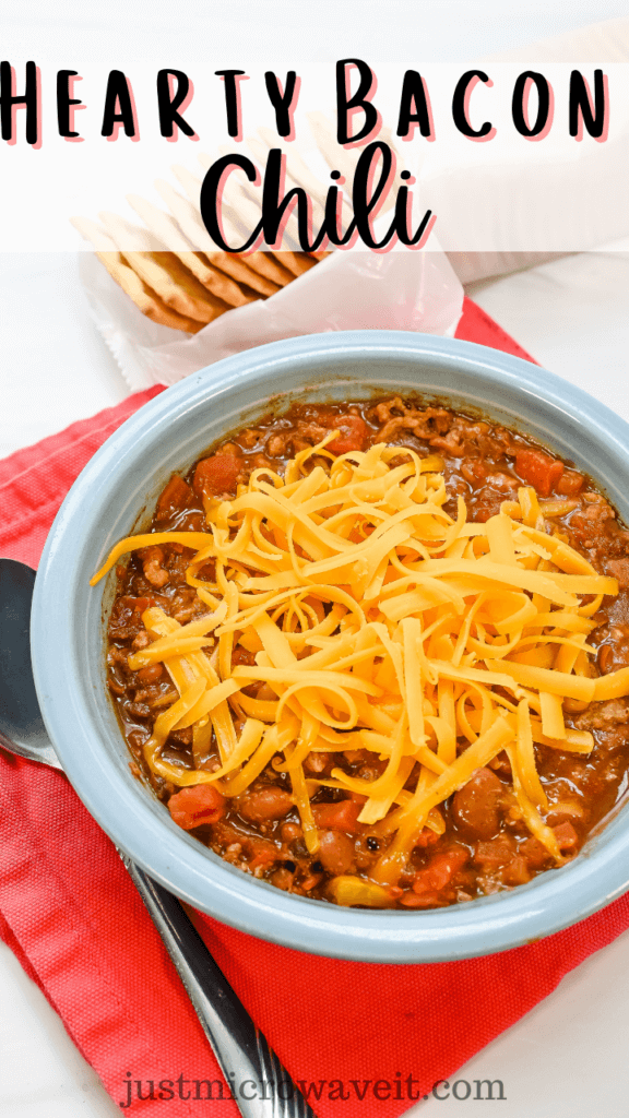 Title image with close up of the blue bowl of chili topped with shredded cheddar on a red napkin next to a spoon with crackers behind it. 