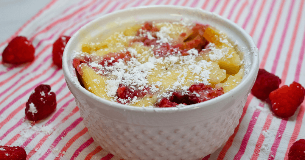 The finished Berry Peach Clafoutis topped in powdered sugar