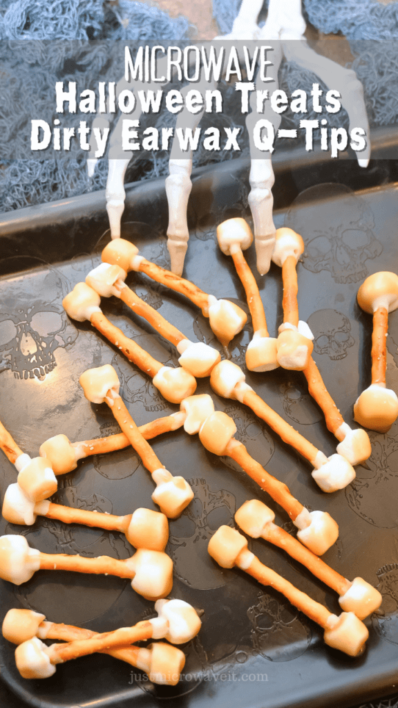 Title image with a bunch of dirty earwax q-tips treats for Halloween in the microwave on a black skull platter with a skeleton hand.